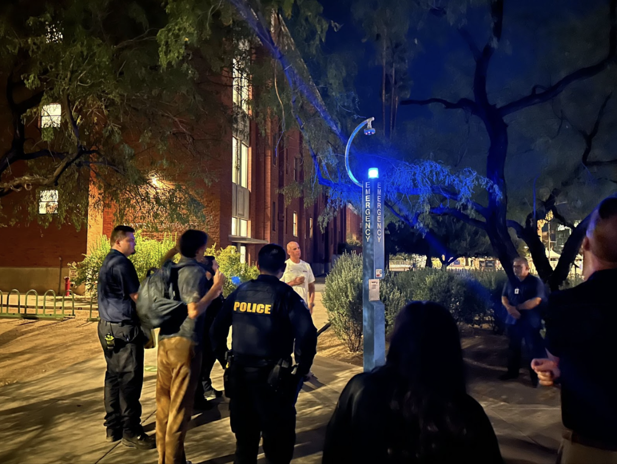 Vice President and Chief Safety Officer Steve Patterson gathers students and staff outside of the Modern Languages building to demonstrate emergency procedures using the Blue Light Emergency Phone. The demonstration occurred during an event called "Safety Stroll with Steve" on Oct. 25. 